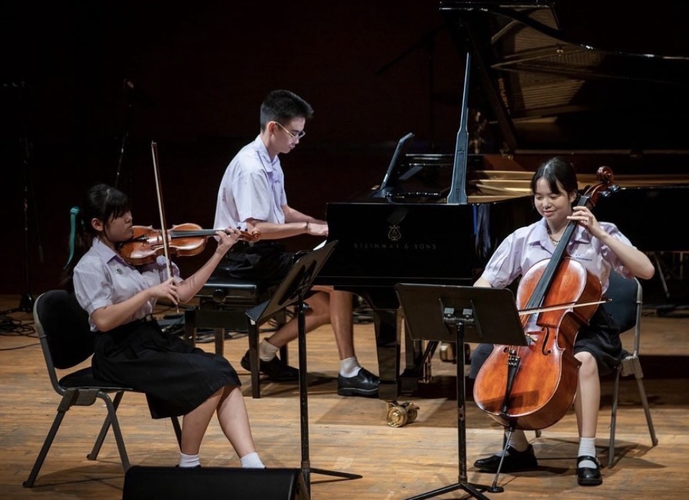 Chachawin performing chamber music with violin and cello
