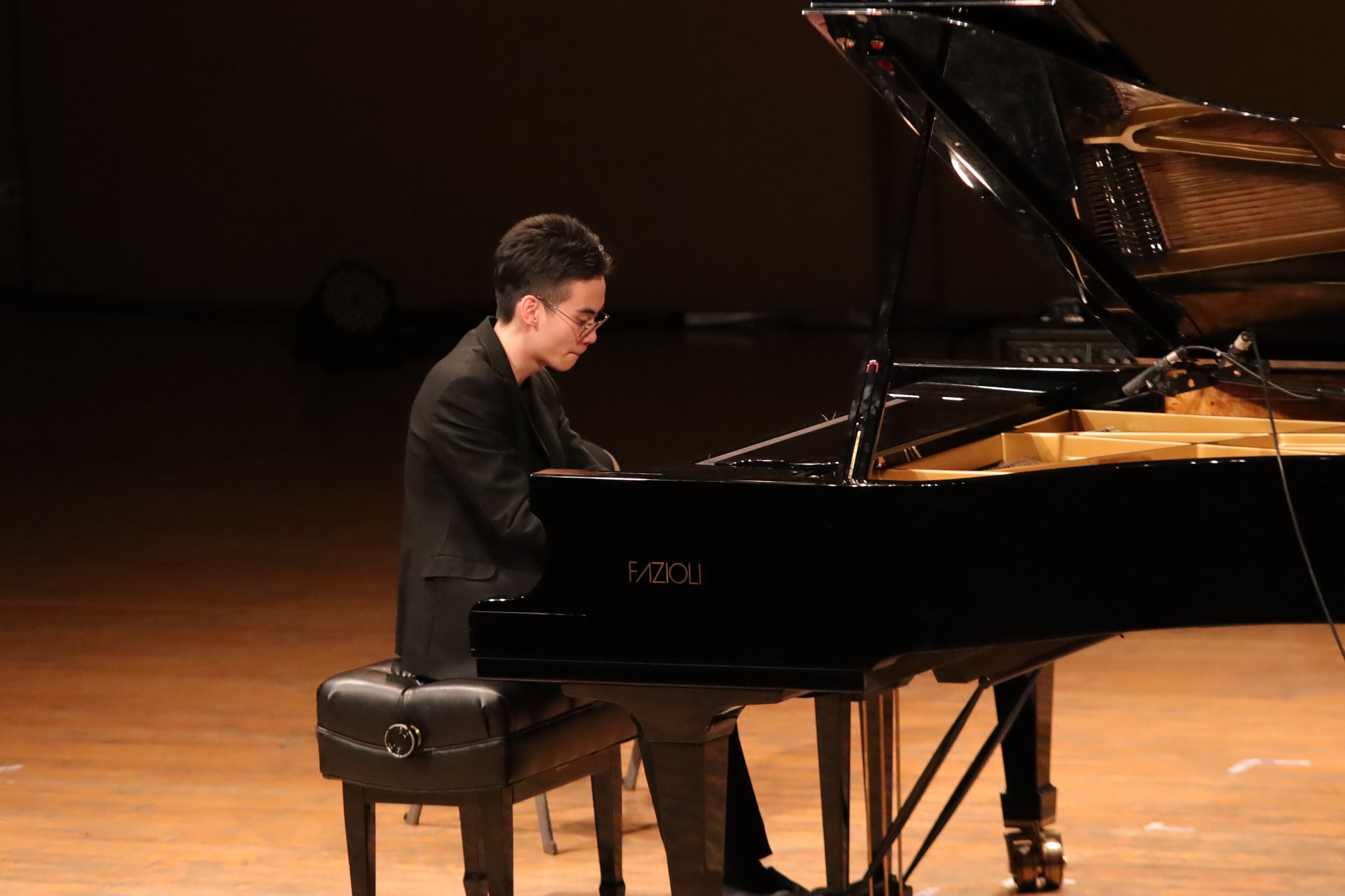 Chachawin performing at a Fazioli grand piano